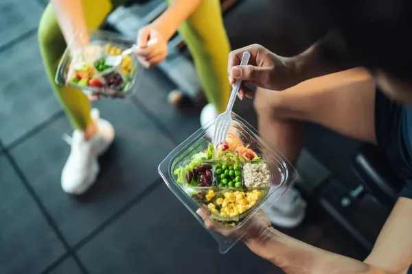 a person holding a nutritional plate of lunch food